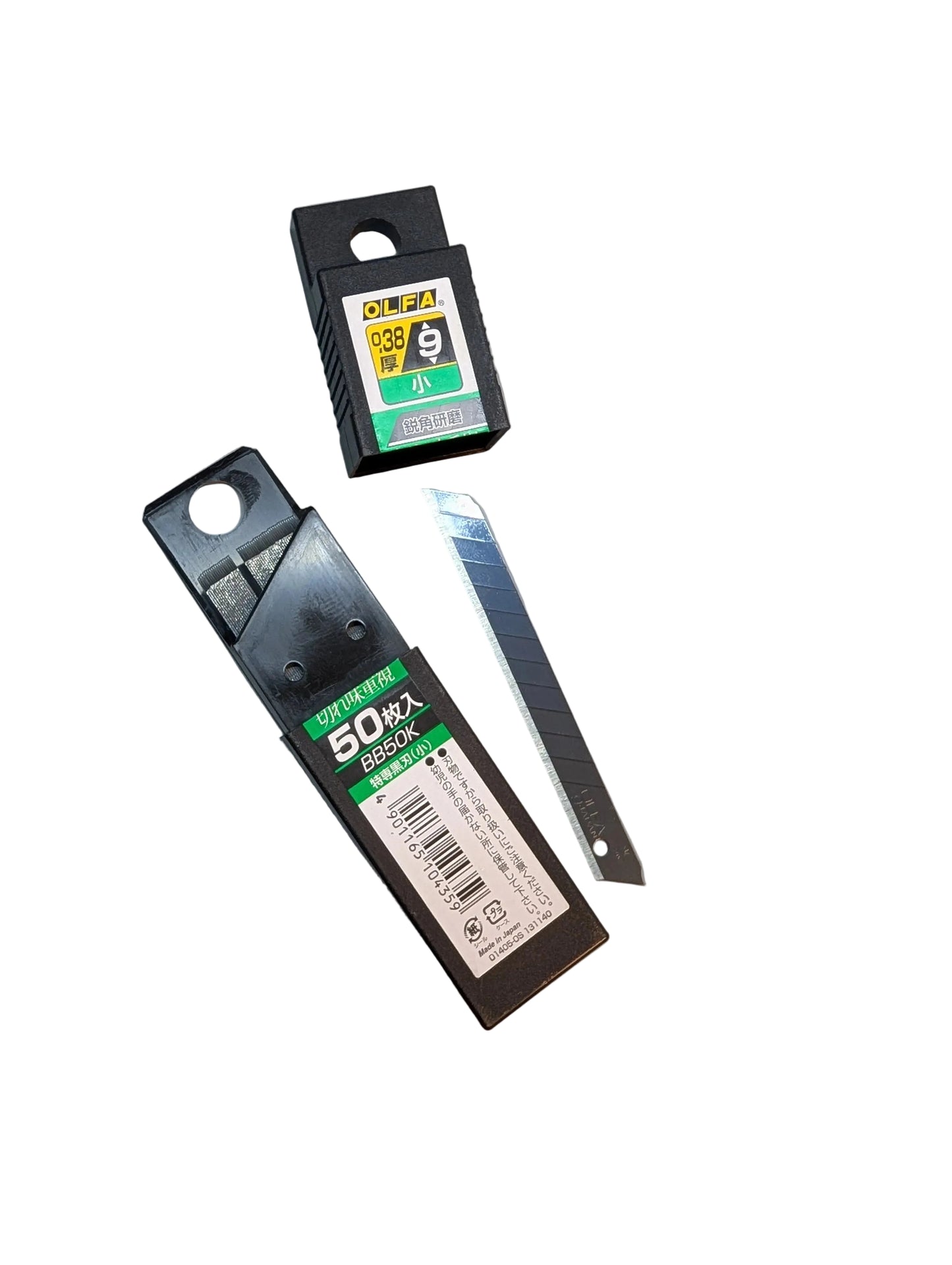 Two utility knives on a cutting mat with visible brand labels.
